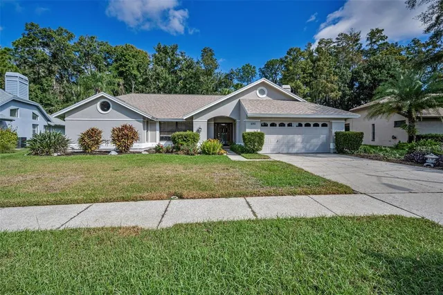 a front view of a house with a yard and garage