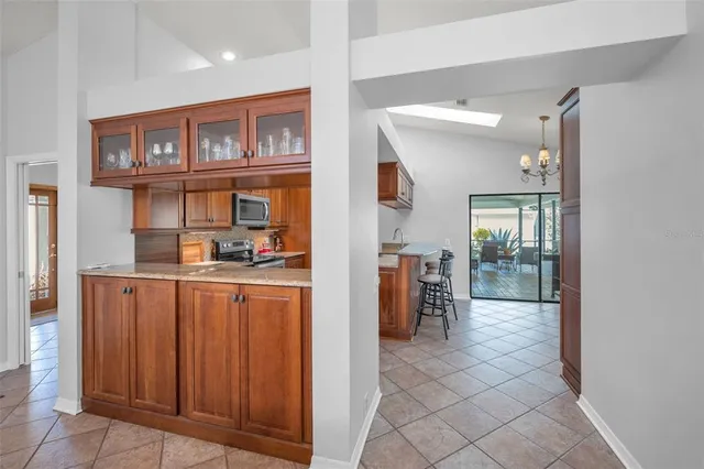 a kitchen with stainless steel appliances granite countertop a refrigerator and a sink