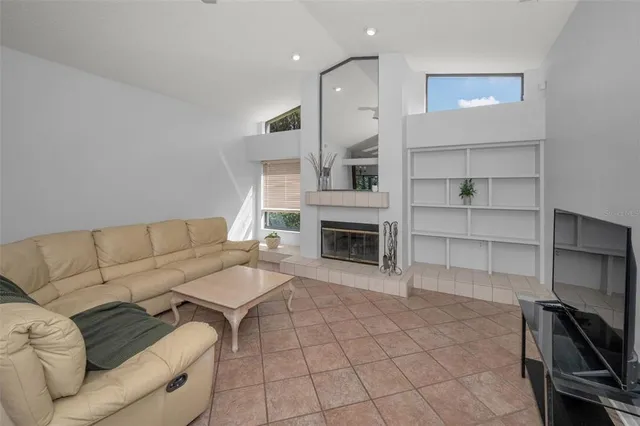 a living room with furniture a fireplace and a piano