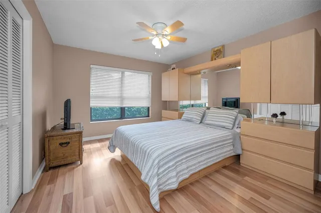 a bathroom with a granite countertop sink a toilet and a window