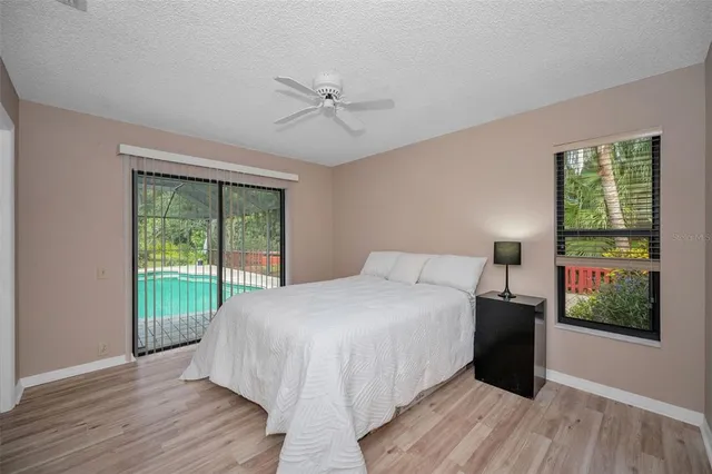 a living room with furniture and floor to ceiling windows