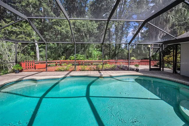 a backyard of a house with lots of green space and plants