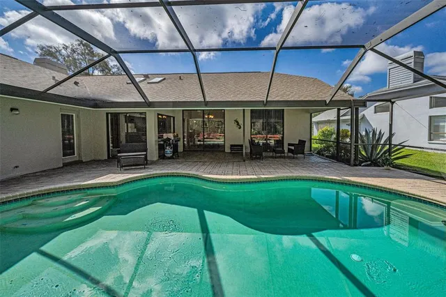 a patio with table and chairs and potted plants