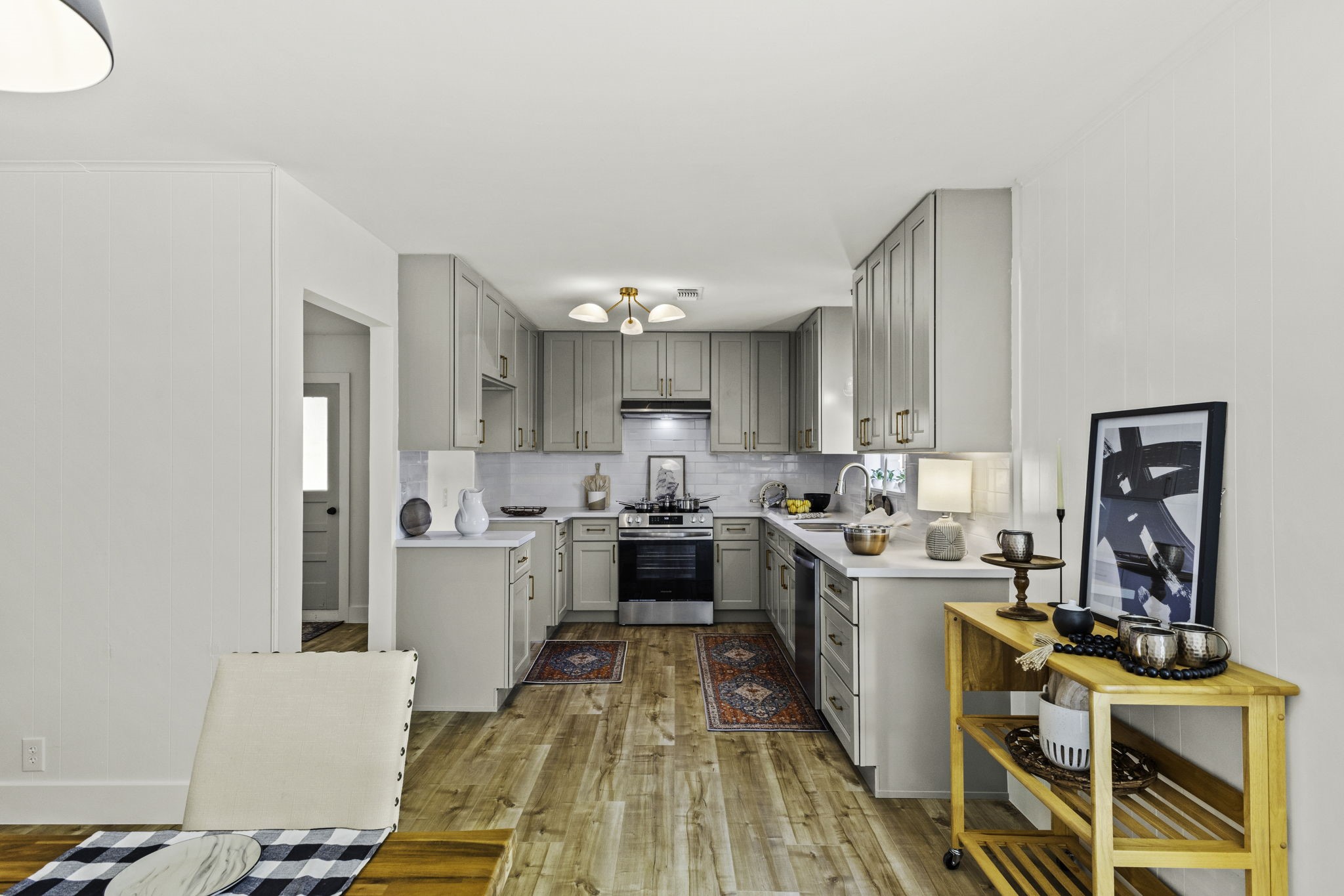 703 Austin Street Columbus, TX 78934 - Photo 20 of 37 a large kitchen with a lot of counter space and wooden floor