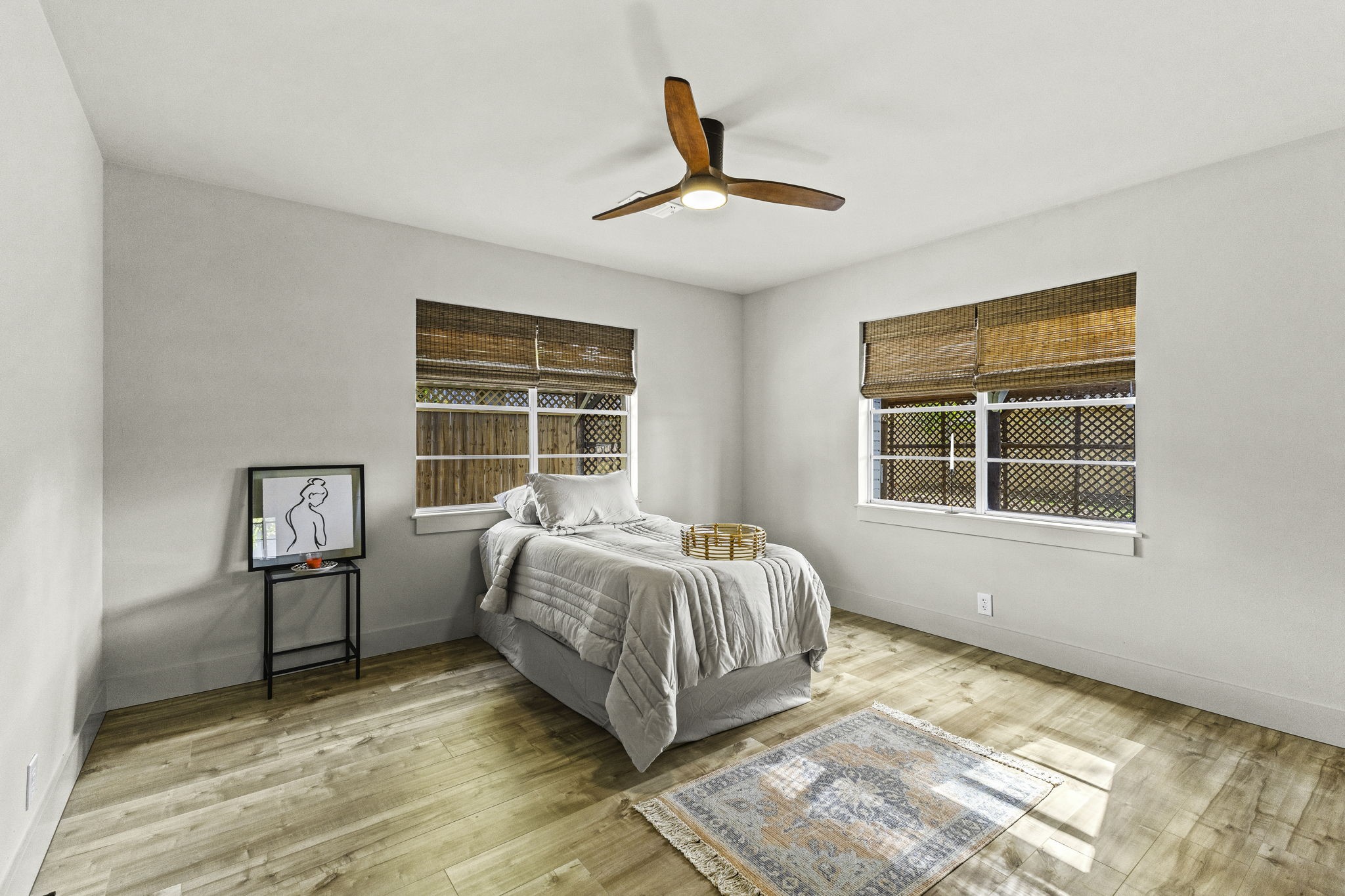 703 Austin Street Columbus, TX 78934 - Photo 29 of 37 a spacious bedroom with a bed and a window