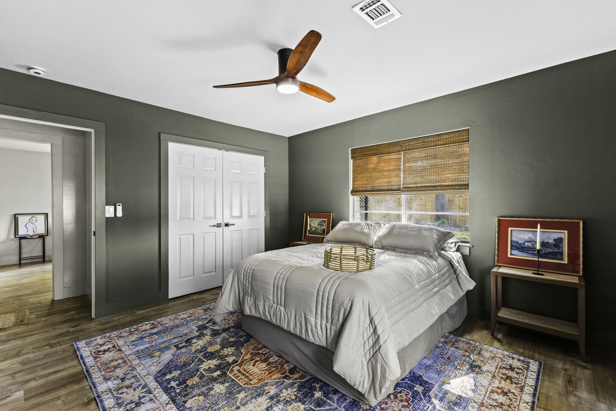 703 Austin Street Columbus, TX 78934 - Photo 32 of 37 a bedroom with a bed and wooden floor