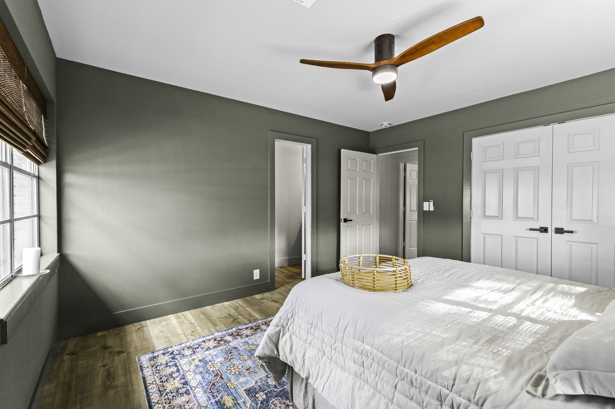 703 Austin Street Columbus, TX 78934 - Photo 33 of 37 a bedroom with a bed and a chandelier