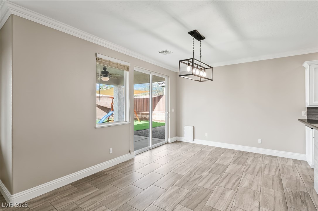 3807 Chapels Royal Street Laughlin, NV 89029 - Photo 15 of 62 Unfurnished dining area featuring crown molding, wood tiled floors, and ceiling fan