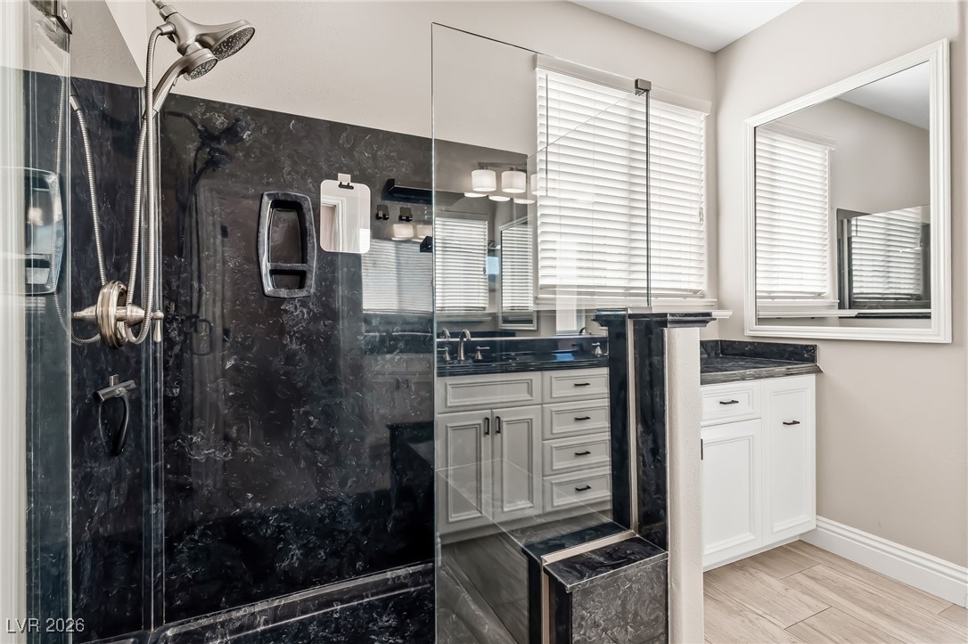 3807 Chapels Royal Street Laughlin, NV 89029 - Photo 26 of 62 Primary Ensuite Bathroom featuring vanity, a marble finish shower, and wood tiled floors