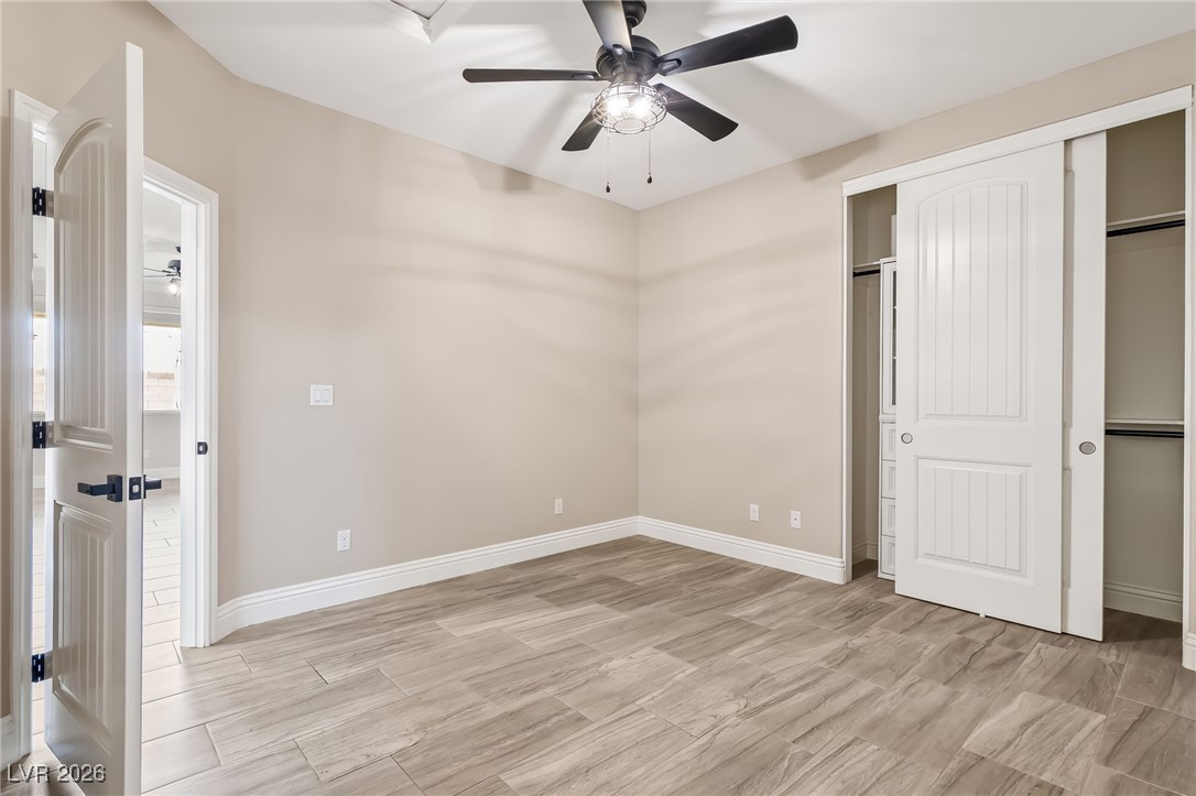 3807 Chapels Royal Street Laughlin, NV 89029 - Photo 33 of 62 Third bedroom with ceiling fan, a closet, and wood tiled floors