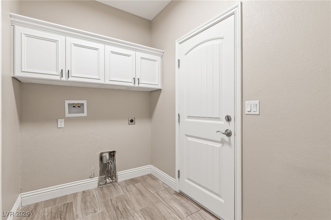 3807 Chapels Royal Street Laughlin, NV 89029 - Photo 37 of 62 Washroom with hookup for a gas dryer, washer hookup, cabinet space, electric dryer hookup, and wood finish floors