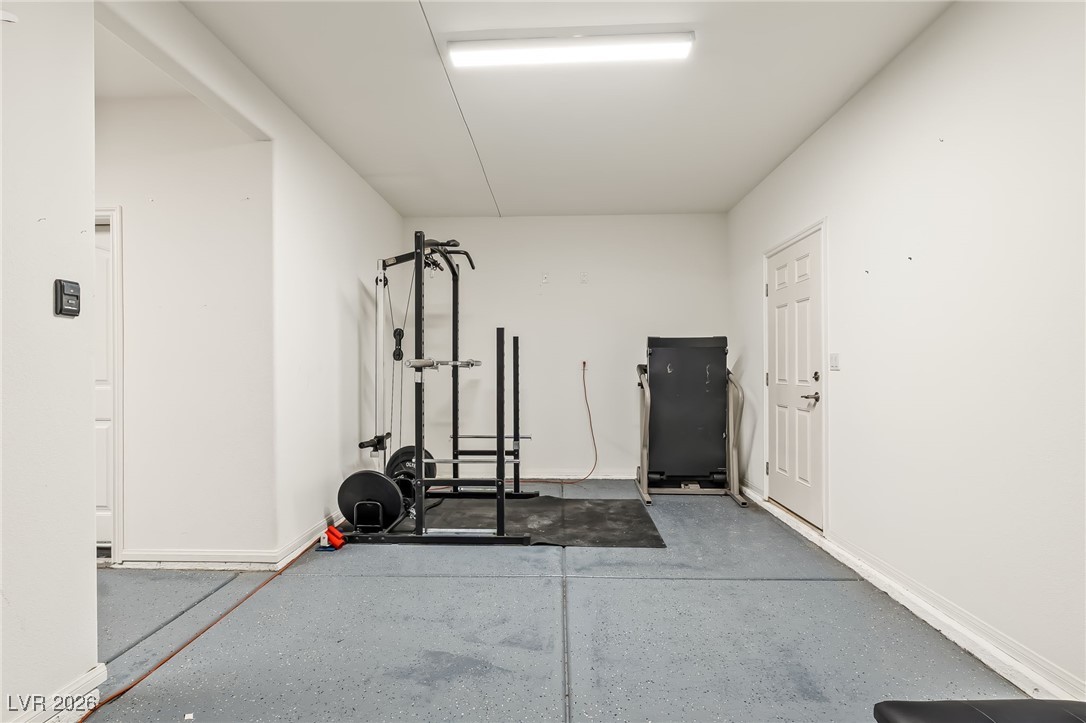 3807 Chapels Royal Street Laughlin, NV 89029 - Photo 40 of 62 Exercise area in garage with concrete floors and baseboards