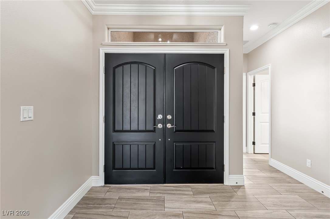 3807 Chapels Royal Street Laughlin, NV 89029 - Photo 4 of 62 Foyer entrance with crown molding and wood finish floors