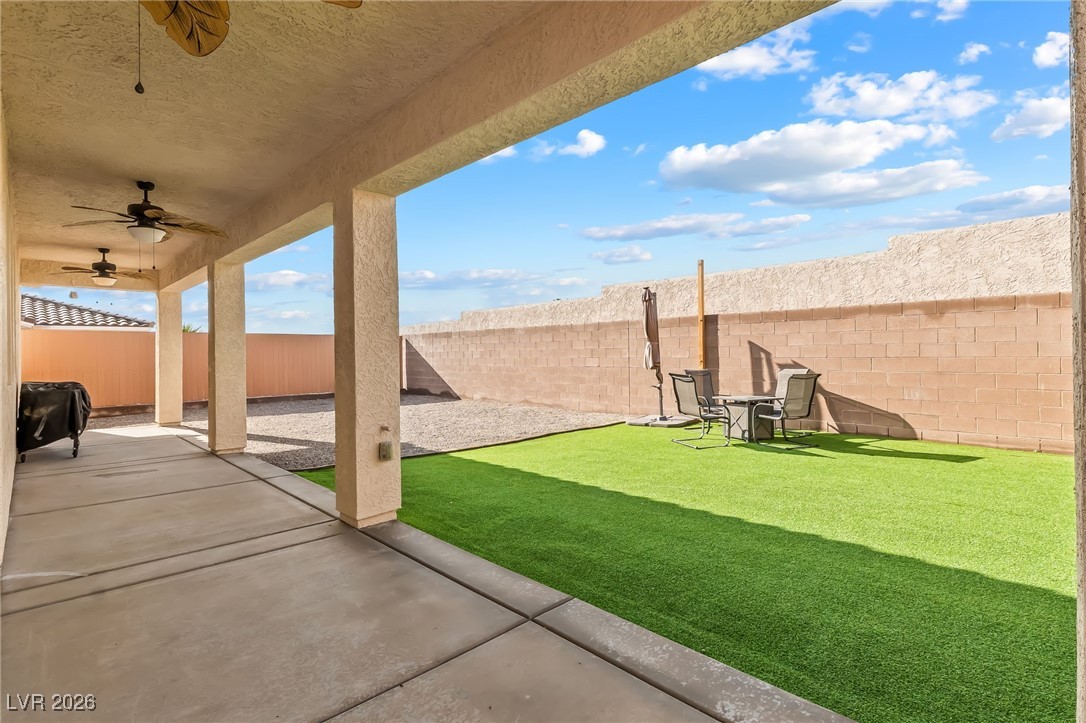 3807 Chapels Royal Street Laughlin, NV 89029 - Photo 42 of 62 Fenced backyard featuring a ceiling fan and a patio