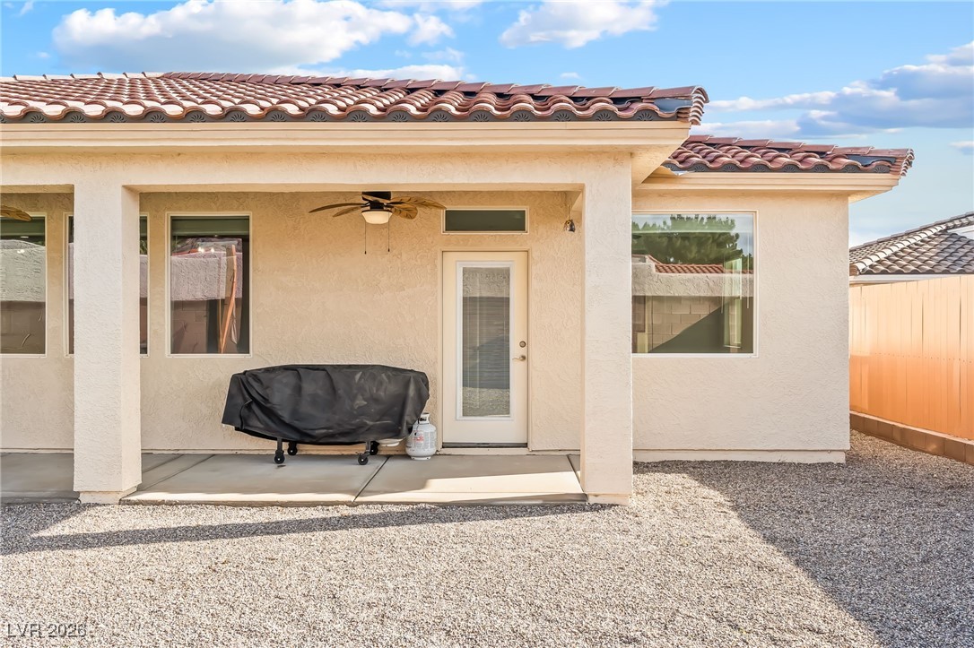 3807 Chapels Royal Street Laughlin, NV 89029 - Photo 46 of 62 Entrance to property featuring ceiling fan, stucco siding, a tile roof, and a patio area