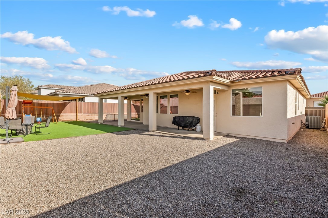3807 Chapels Royal Street Laughlin, NV 89029 - Photo 47 of 62 Back of property with a patio area, a tile roof, stucco siding, and a fenced backyard