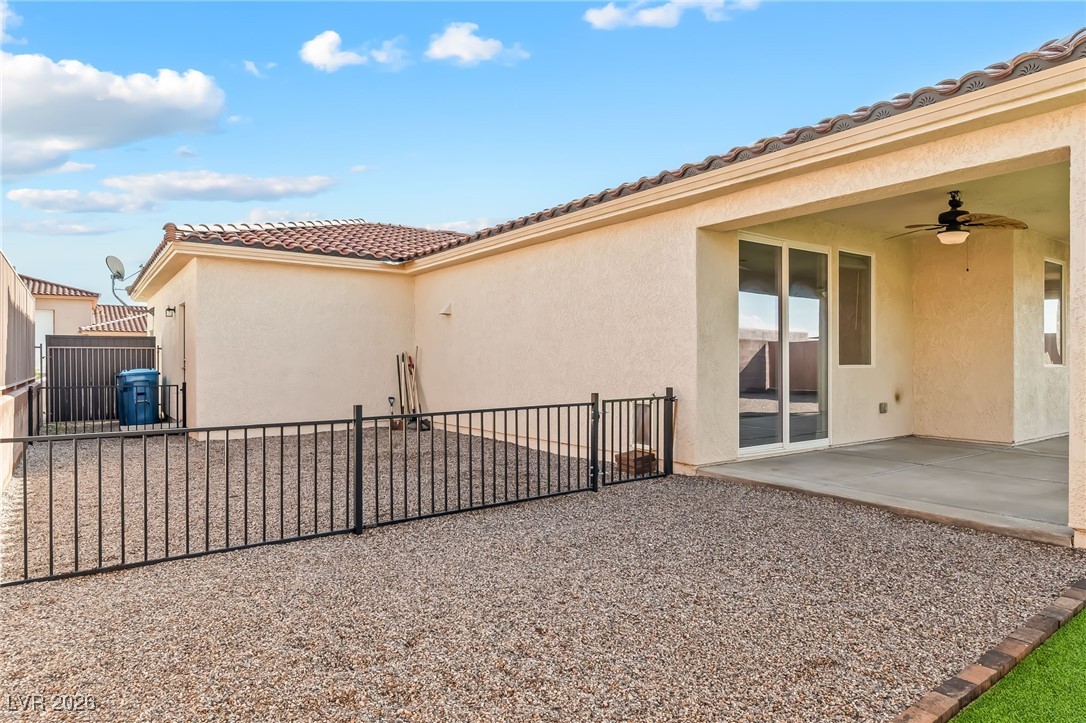 3807 Chapels Royal Street Laughlin, NV 89029 - Photo 50 of 62 View of property exterior with a patio, stucco siding, a tiled roof, and ceiling fan