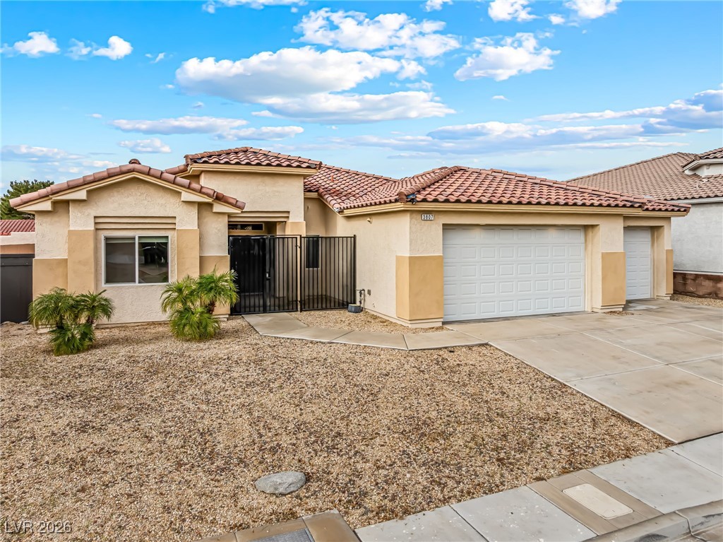 3807 Chapels Royal Street Laughlin, NV 89029 - Photo 55 of 62 Mediterranean / spanish house featuring stucco siding, a garage, concrete driveway, and a tile roof