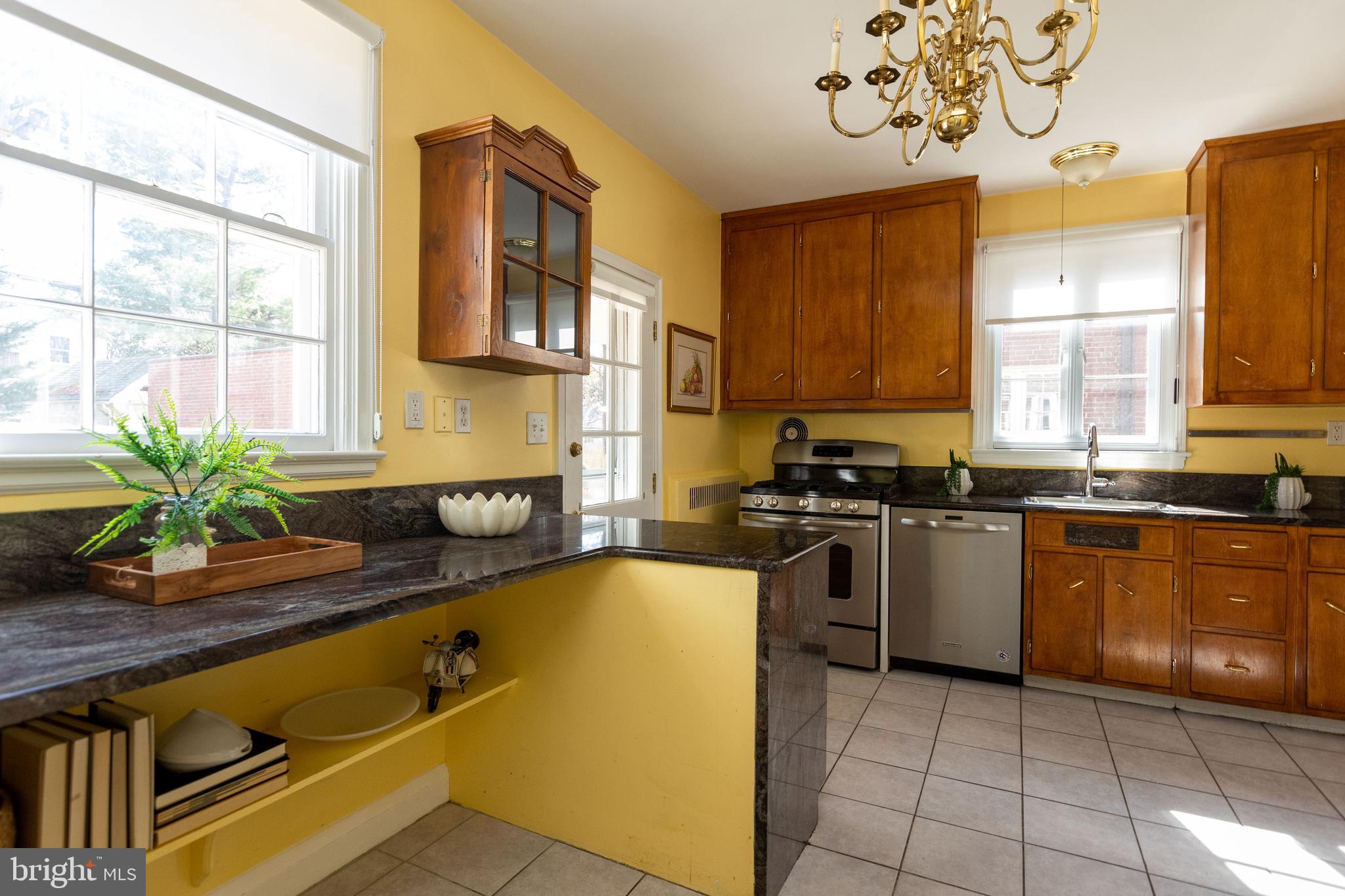 331 Broxton Road Baltimore, MD 21212 - Photo 12 of 58 a kitchen with stainless steel appliances granite countertop a sink a counter space and cabinets