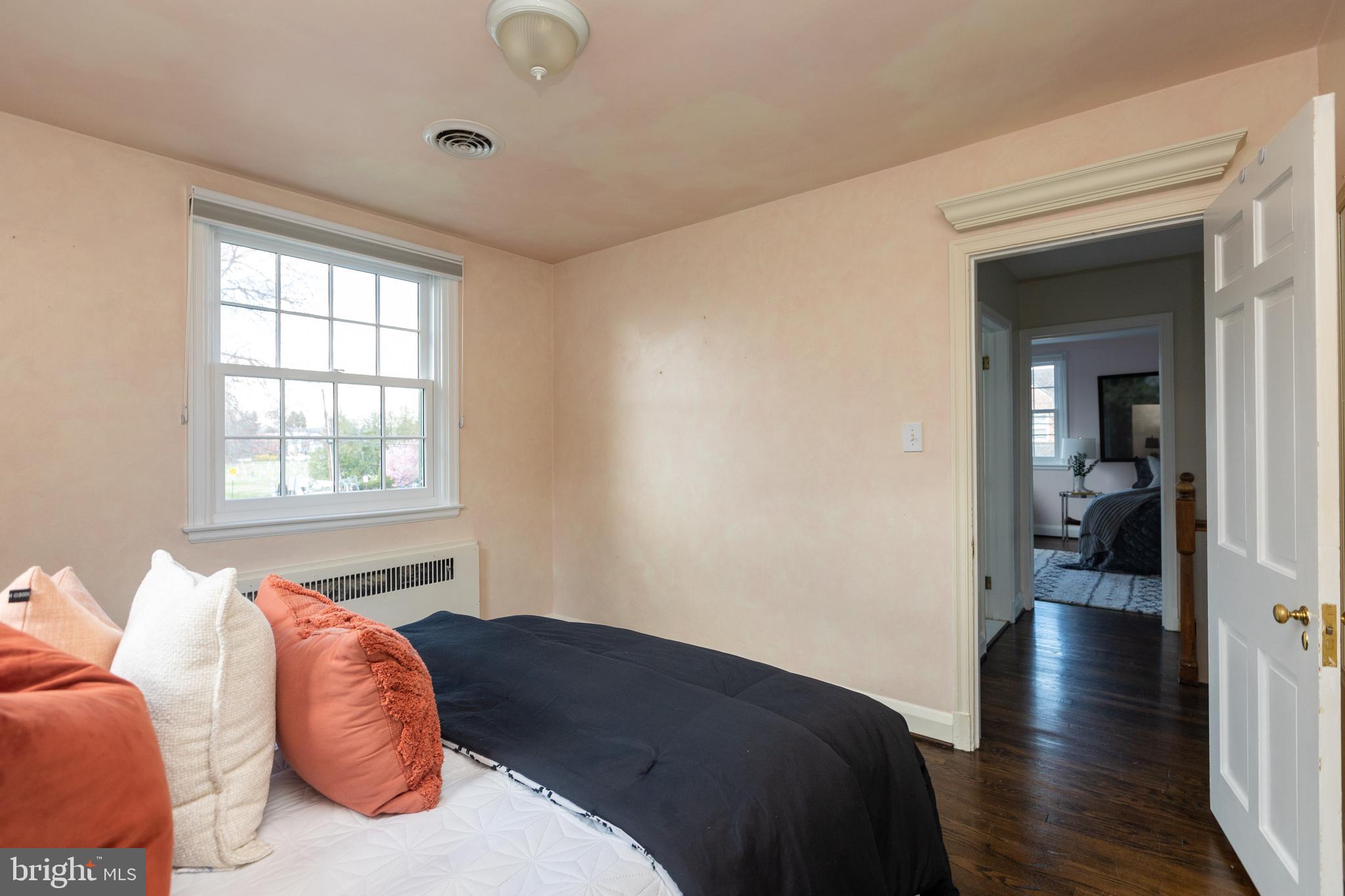 331 Broxton Road Baltimore, MD 21212 - Photo 37 of 58 a bedroom with a bed and wooden floor