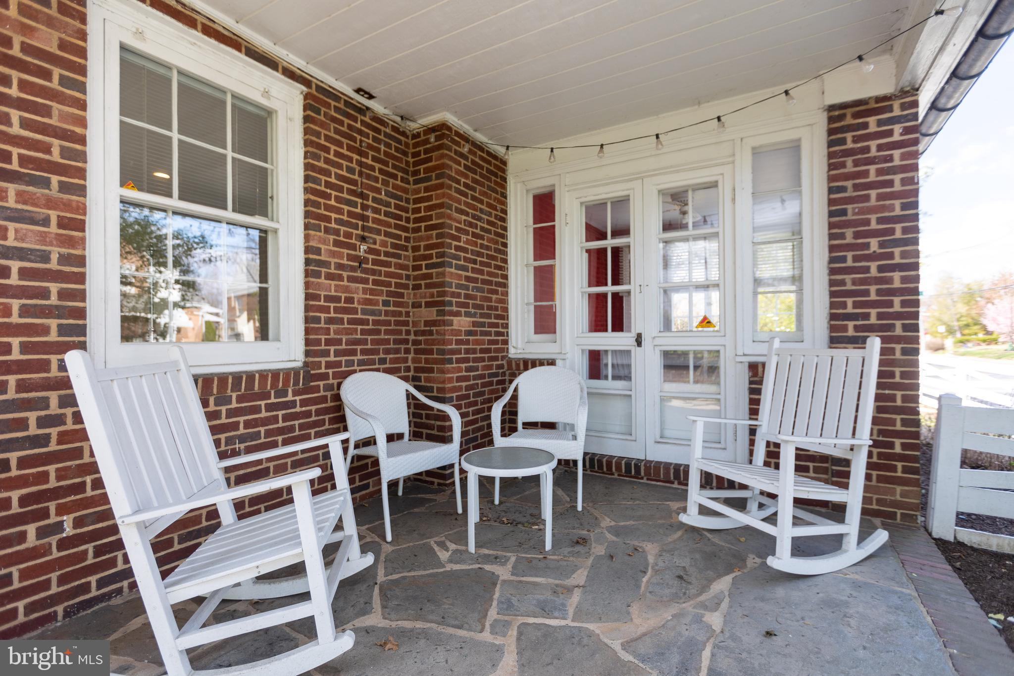 331 Broxton Road Baltimore, MD 21212 - Photo 8 of 58 a patio with table and chairs and potted plants