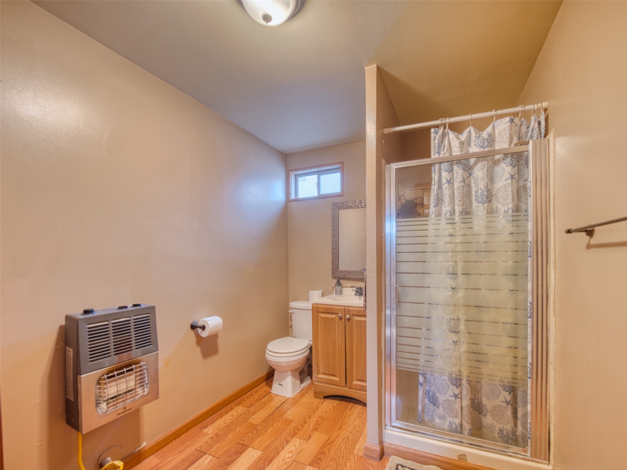 2900 Castro Street Austin, TX 78702 - Photo 27 of 39 Bathroom featuring heating unit, vanity, toilet, and wood-style flooring
