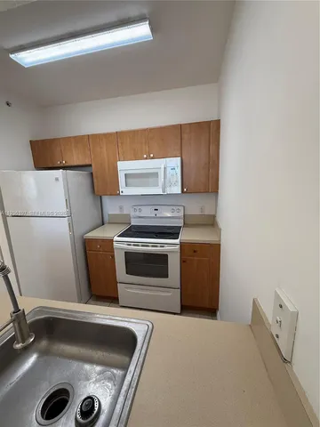 a kitchen with a sink and a stove