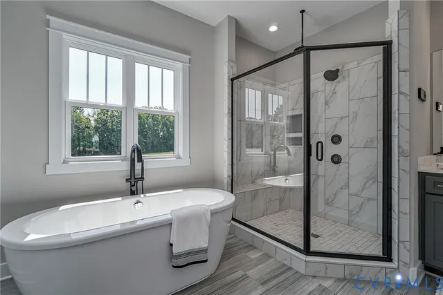 a bathroom with a bathtub and a shower