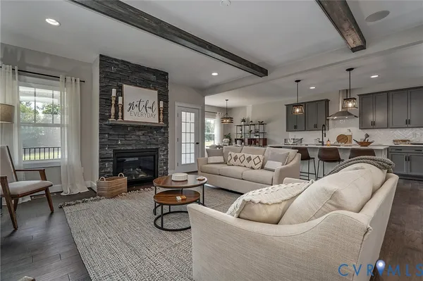 a living room with fireplace furniture and a wooden floor