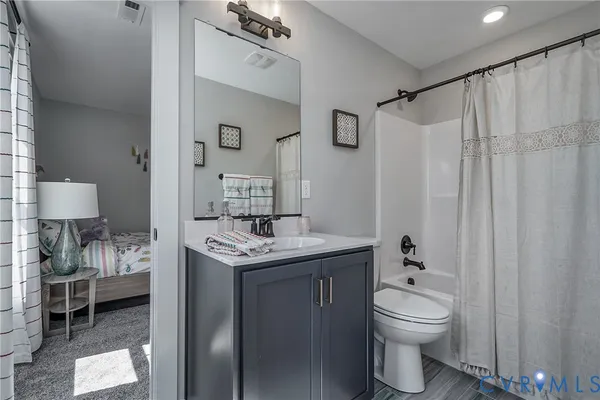 a bedroom with a bed and a view of bathroom
