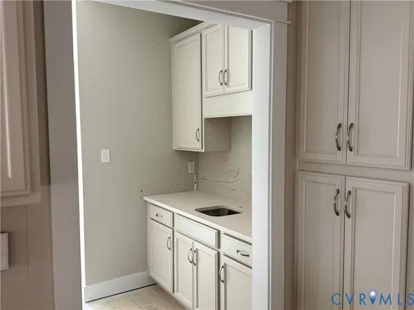 a kitchen with a sink and cabinets