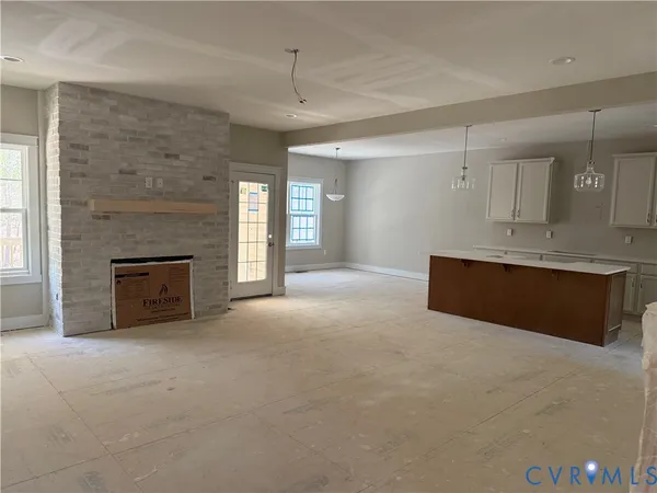 a view of a livingroom with a fireplace and window