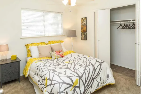 a bedroom with a bed and window