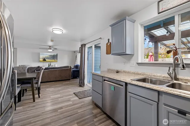 a kitchen with a sink cabinets and wooden floor