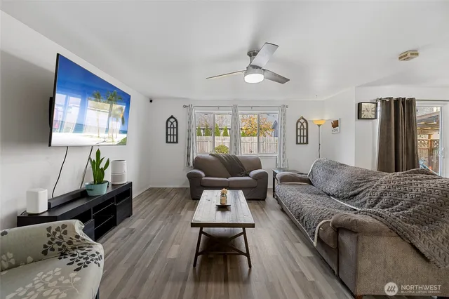 a living room with furniture and wooden floor