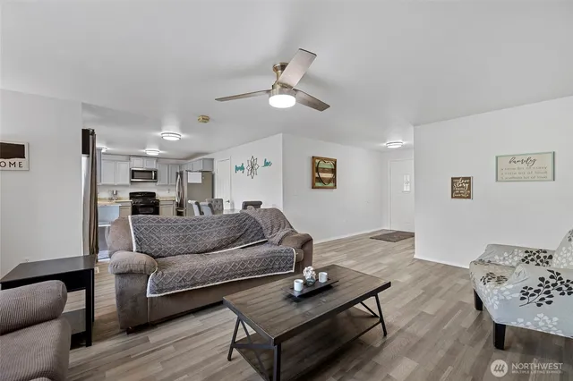 a living room with furniture and a wooden floor