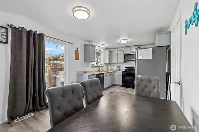 a living room with furniture and a refrigerator