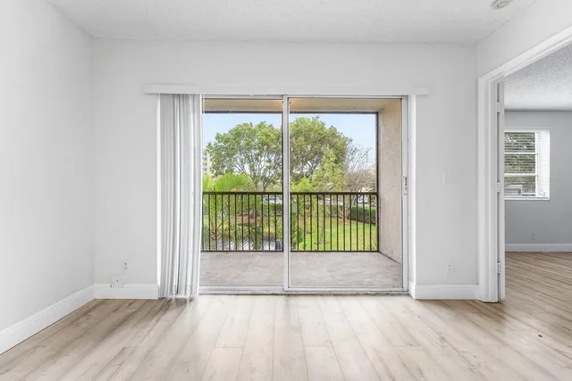 a view of a room with wooden floor and a window