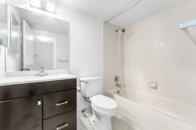 a bathroom with a sink toilet vanity and shower