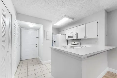 a kitchen with stainless steel appliances a sink stove and cabinets
