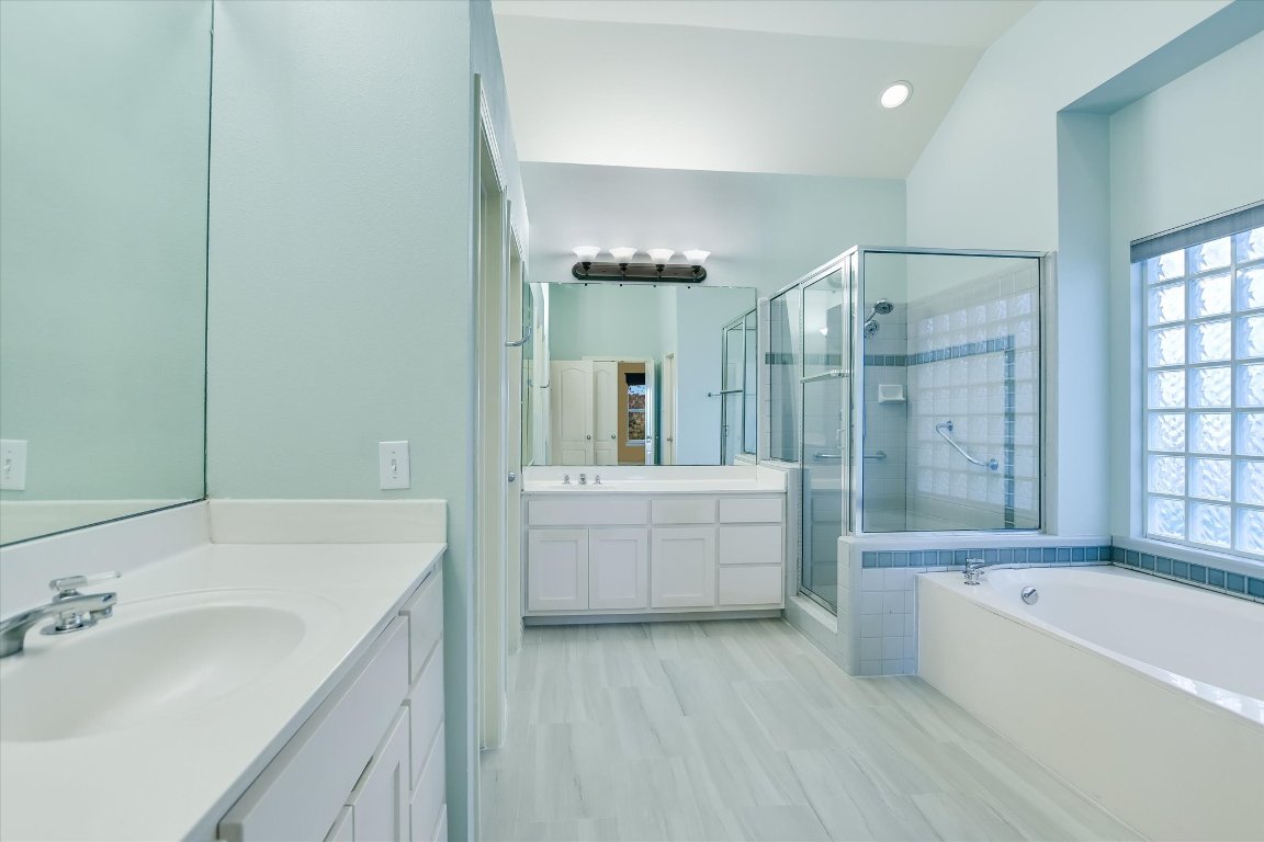 4819 Spicewood Springs Road Austin, TX 78759 - Photo 11 of 20 a bathroom with a tub a sink shower double vanity