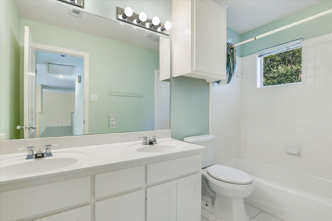 4819 Spicewood Springs Road Austin, TX 78759 - Photo 14 of 20 a bathroom with a sink a toilet and shower