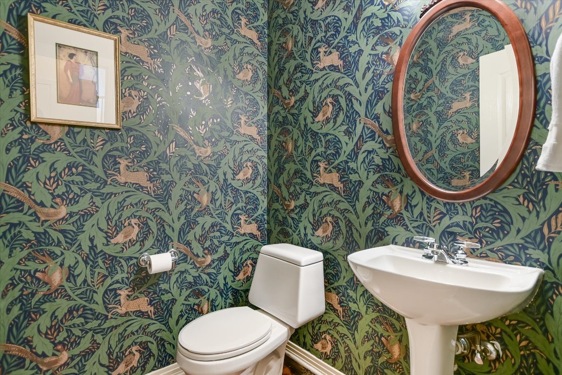 4819 Spicewood Springs Road Austin, TX 78759 - Photo 16 of 20 a bathroom with a toilet a sink and a mirror