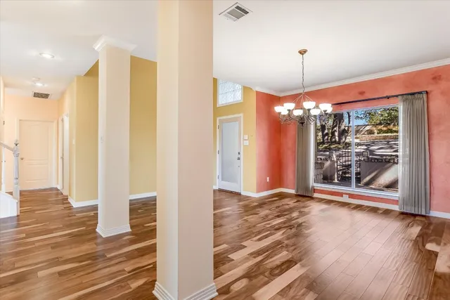 a view of a room with wooden floor and a fireplace