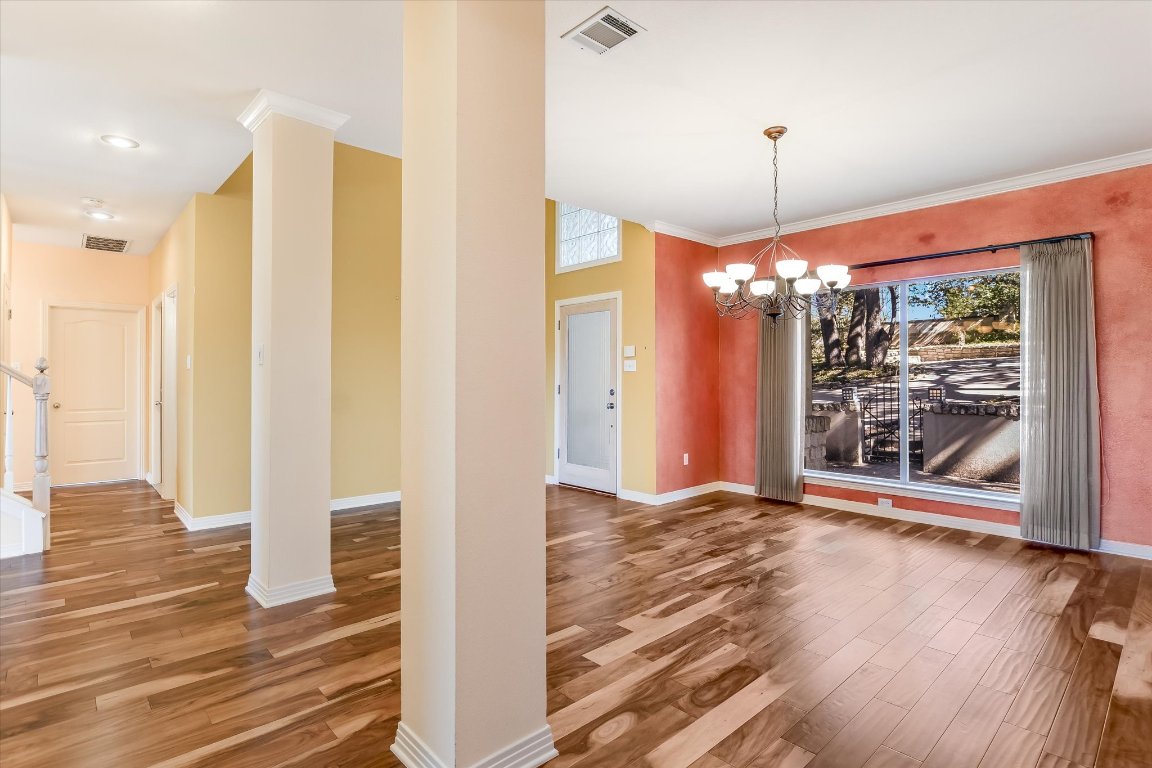 4819 Spicewood Springs Road Austin, TX 78759 - Photo 4 of 20 a view of a room with wooden floor and a fireplace