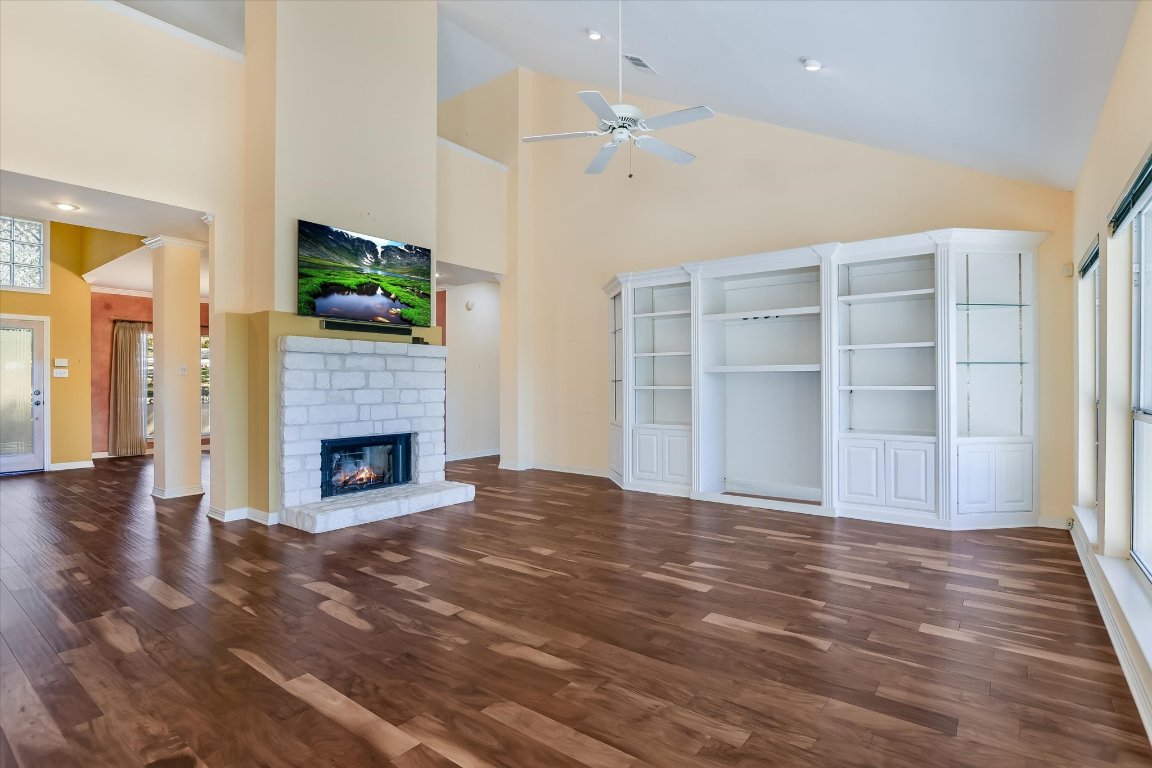4819 Spicewood Springs Road Austin, TX 78759 - Photo 7 of 20 a view of empty room with wooden floor and fireplace