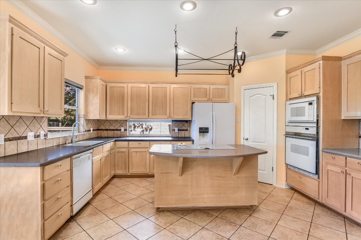 4819 Spicewood Springs Road Austin, TX 78759 - Photo 8 of 20 a kitchen with stainless steel appliances a refrigerator sink and cabinets