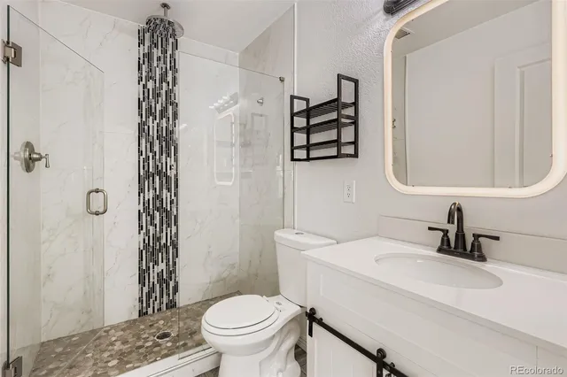 a bathroom with a sink toilet and shower