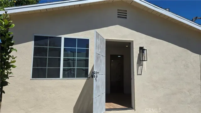 a view of hallway with wooden floor