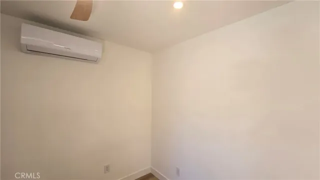 a view of hallway with bathroom and wooden floor